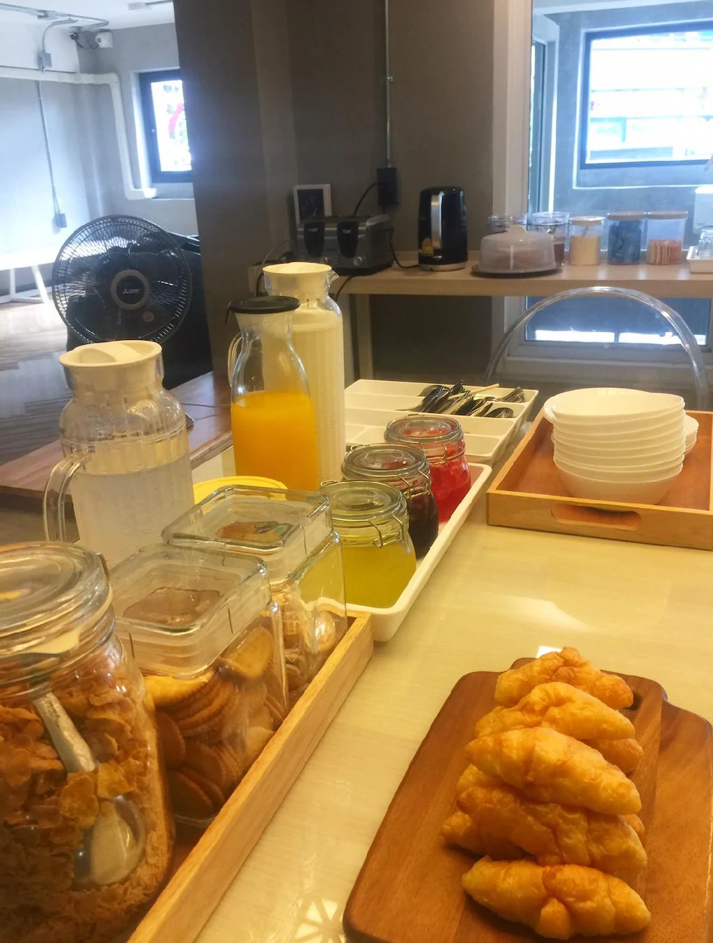 Free breakfast spread with croissants, juice, cereal and jams