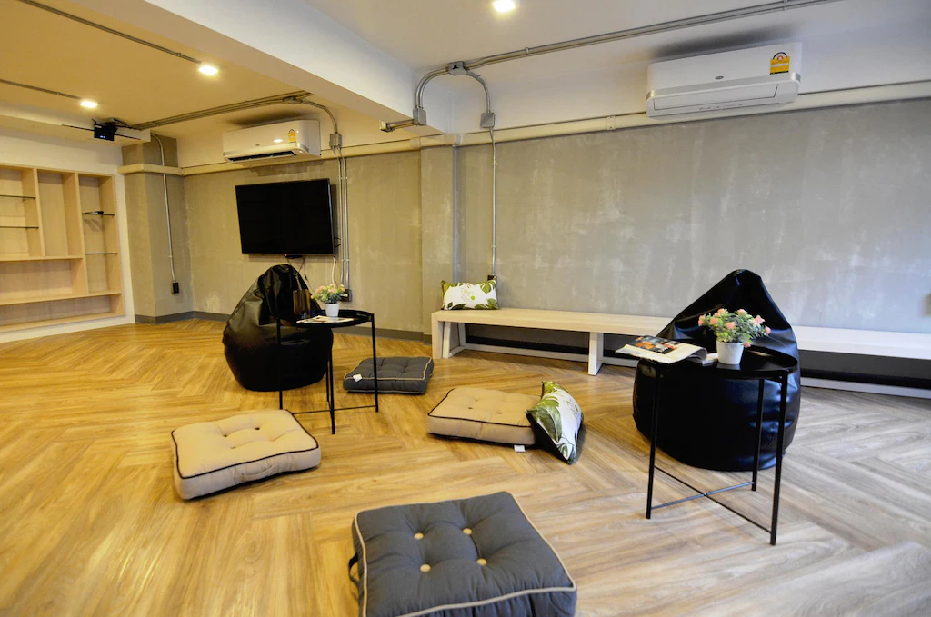 Lounge with bean bags, floor cushions and a big TV
